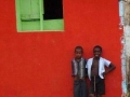 Boys and red house with green windows. Miches